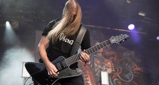 Fredrik Thordendal of Meshuggah shreds on his Ibanez custom 8-string, his face obscured by his hair