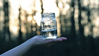 moon water in a mason jar in the woods