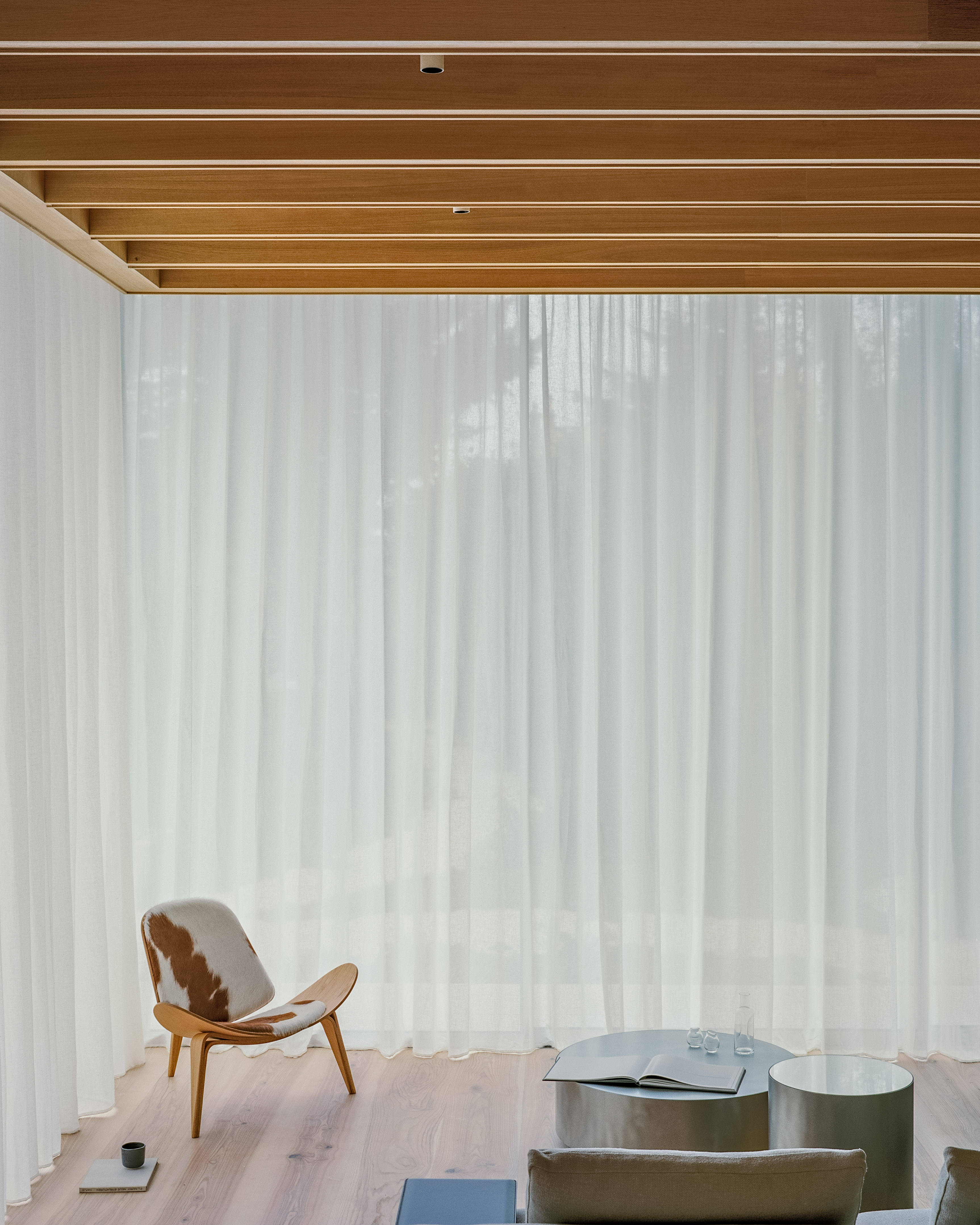 views of Panoramic House by Mata with a timber clad extension and built in furniture