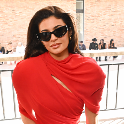 Kylie Jenner wearing sunglasses and a red dress