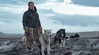 Joe Cole, with two dogs, as Iver P. Iversen in Against the Ice