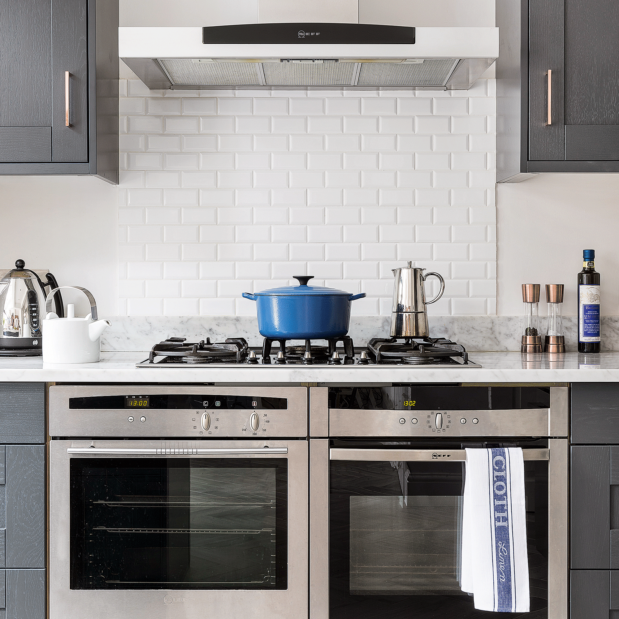 Kitchen with silver ranger and blue casserole dish