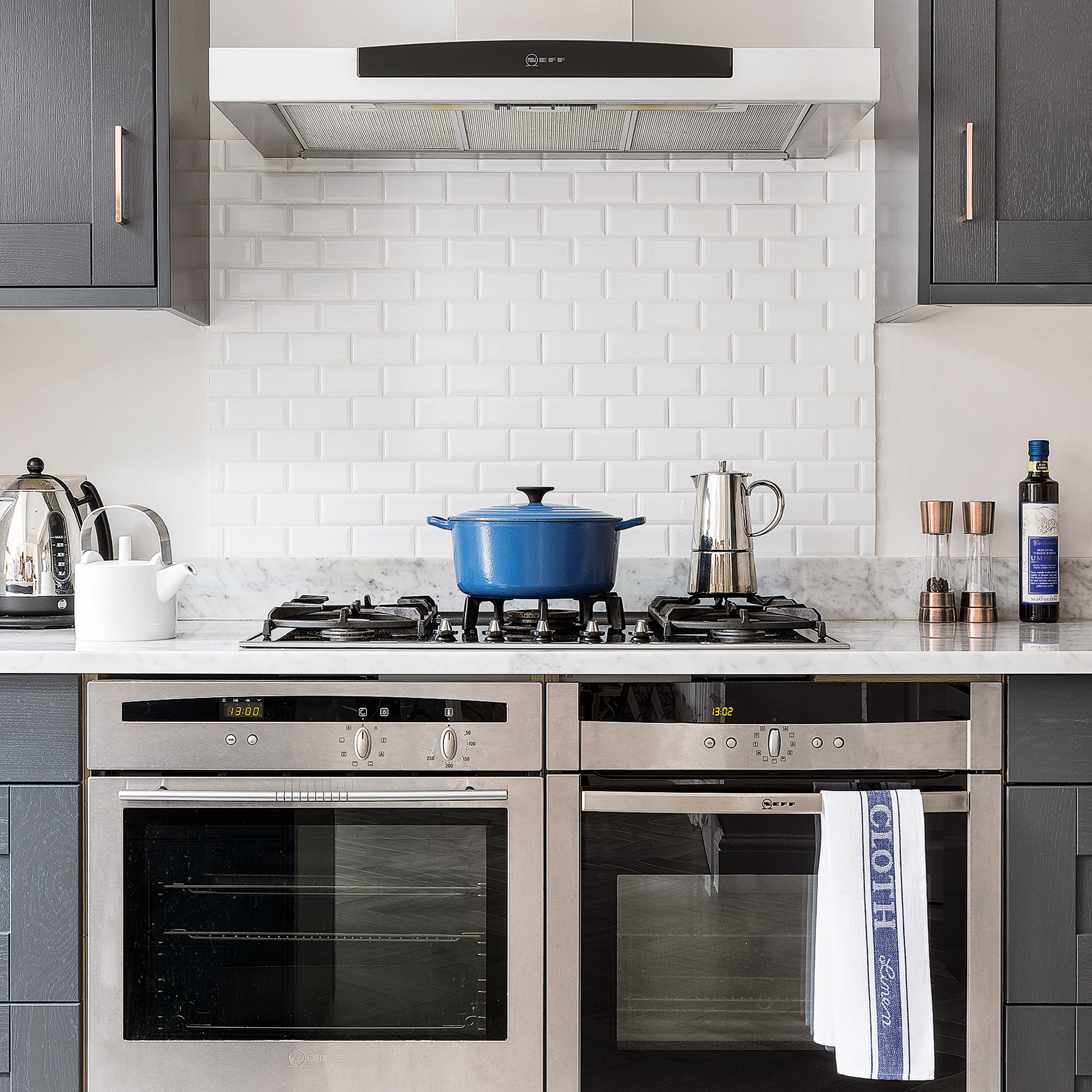 Kitchen with silver range and blue casserole dish