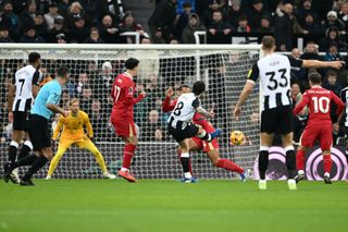 Sandro Tonali of Newcastle United has a shot, which is saved by Caoimhin Kelleher of Liverpool, during the Premier League match between Newcastle United FC and Liverpool FC at St James' Park on December 04, 2024 in Newcastle upon Tyne, England.