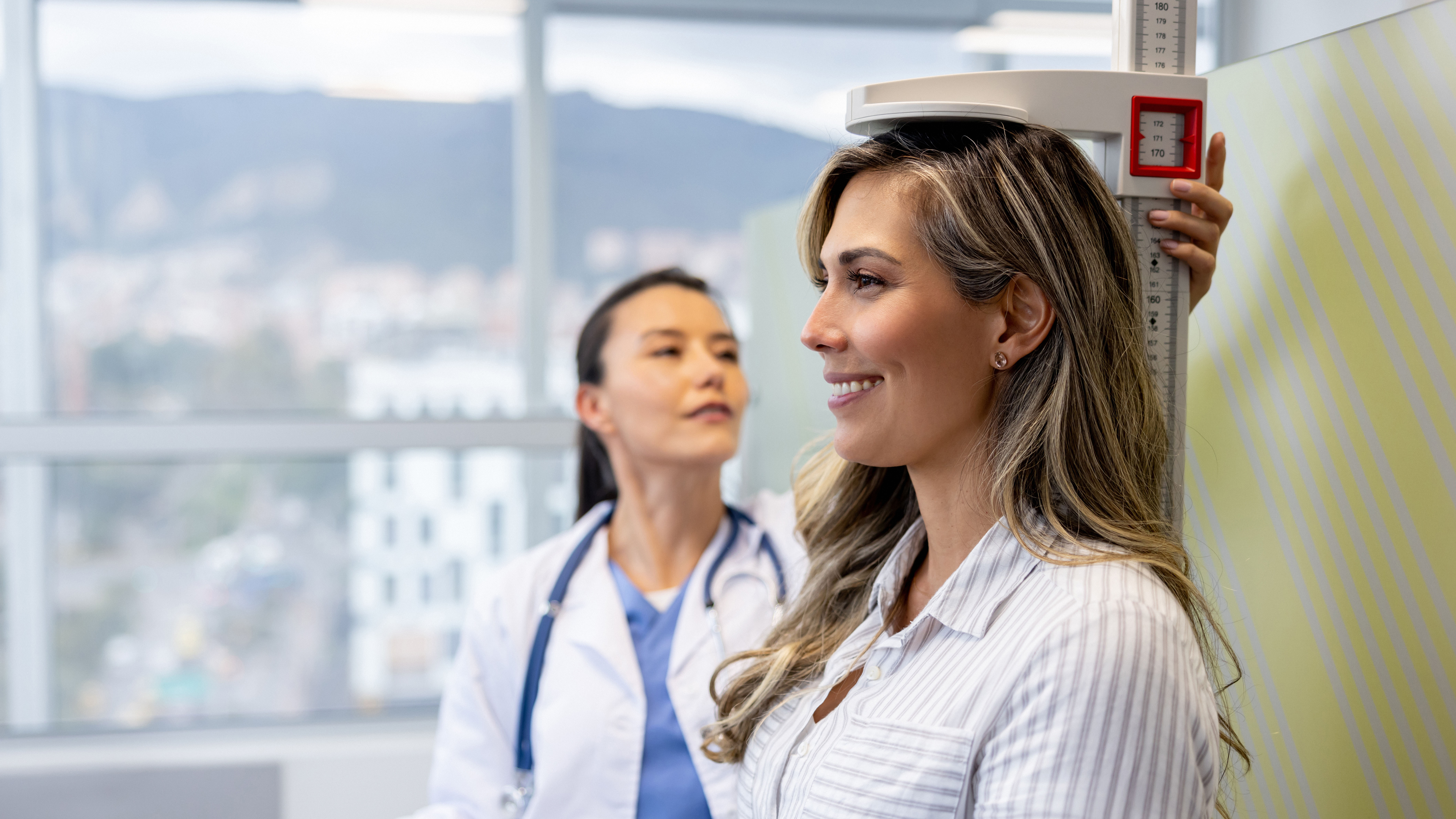 Doctor measuring patient's height