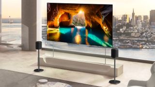 The LG Wallpaper W6 OLED on a glass panel in front of a city skyline.