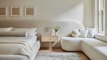 white bedroom with extended headboard that turns into window seat