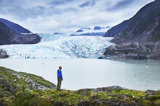 Male hiker gazing at Mendenhall Glacier, Juneau, Alaska, USA