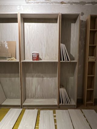 Empty shelving units primed with paint