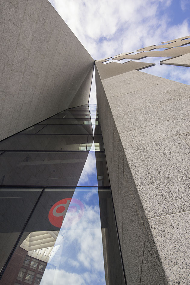 A view of a building outside looking upwards the glass panes