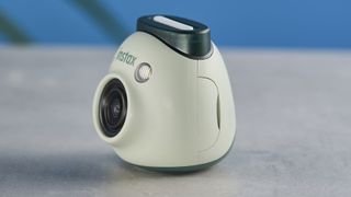 A pistachio green Fujifilm Instax Pal digital camera