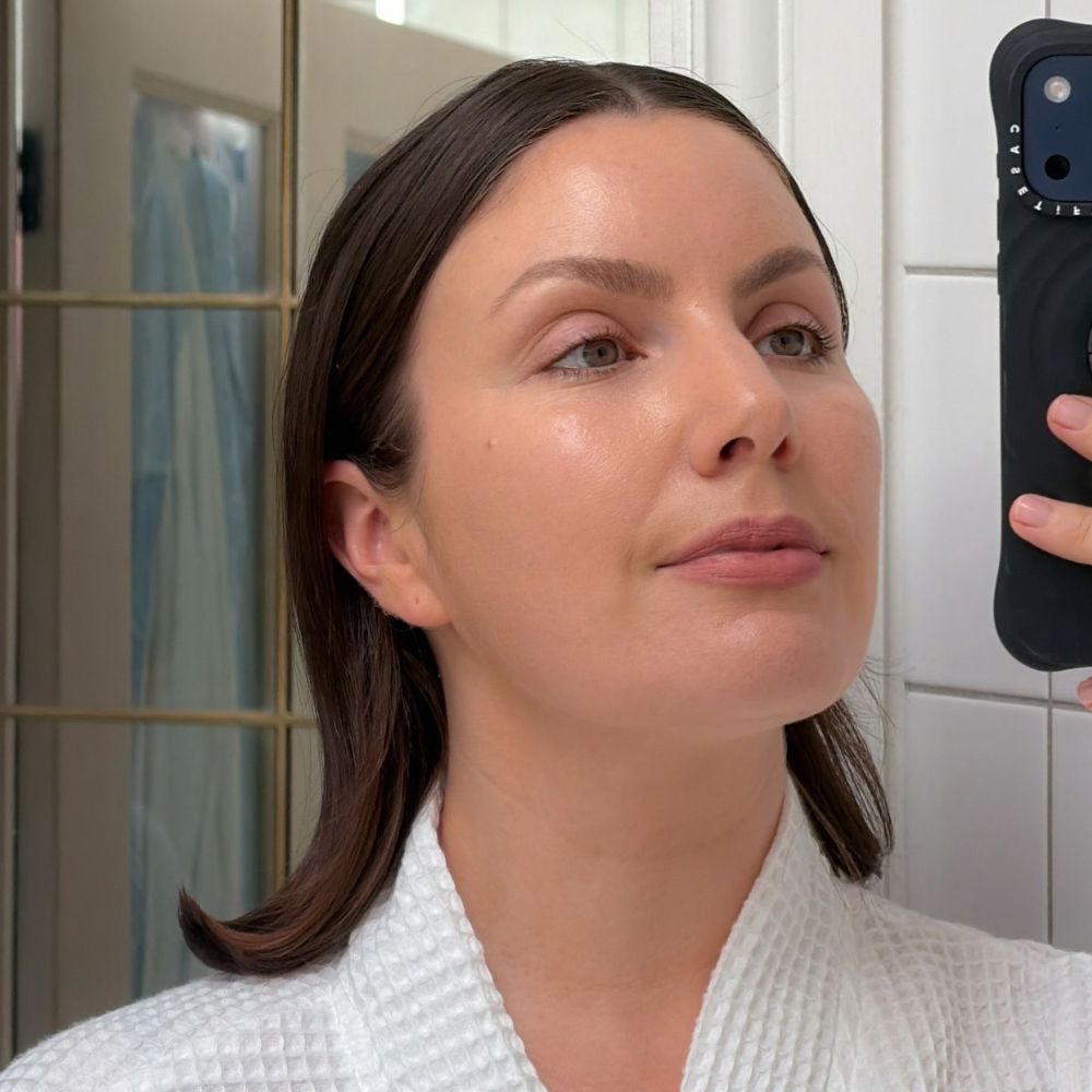 Creator @emmahoareau taking a selfie wearing a bath robe with glowing skin