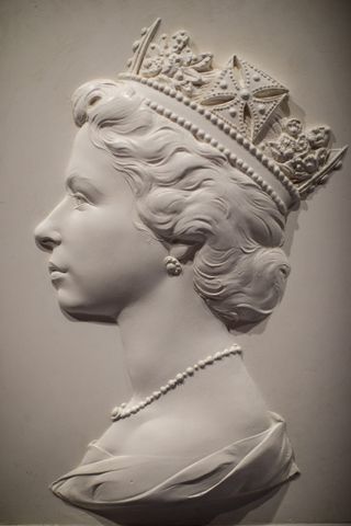 The Queen LONDON, ENGLAND - JULY 28: The 1963 plaster cast known as the 'Dressed Head' by Arnold Machin, which provided the portrait of Queen Elizabeth II to be used on British stamps from 1967, on display at the Postal Museum on July 28, 2017 in London, England. The Postal Museum opens to the public today and features artefacts from 500 years of postal history. Mail Rail, which opens September 4, 2017, is a 1km long section of the underground railway network which was built to transport letters and parcels between 1927 and 2003. (Photo by Jack Taylor/Getty Images)