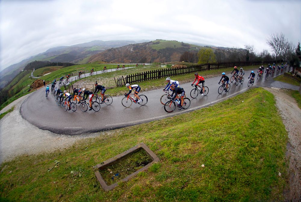 The peloton takes a slippery corner.