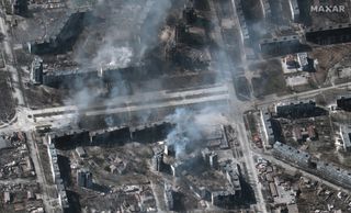 Maxar Technologies' Worldview-3 satellite captured this image of buildings on fire in the Ukrainian city of Mariupol on March 22, 2022.