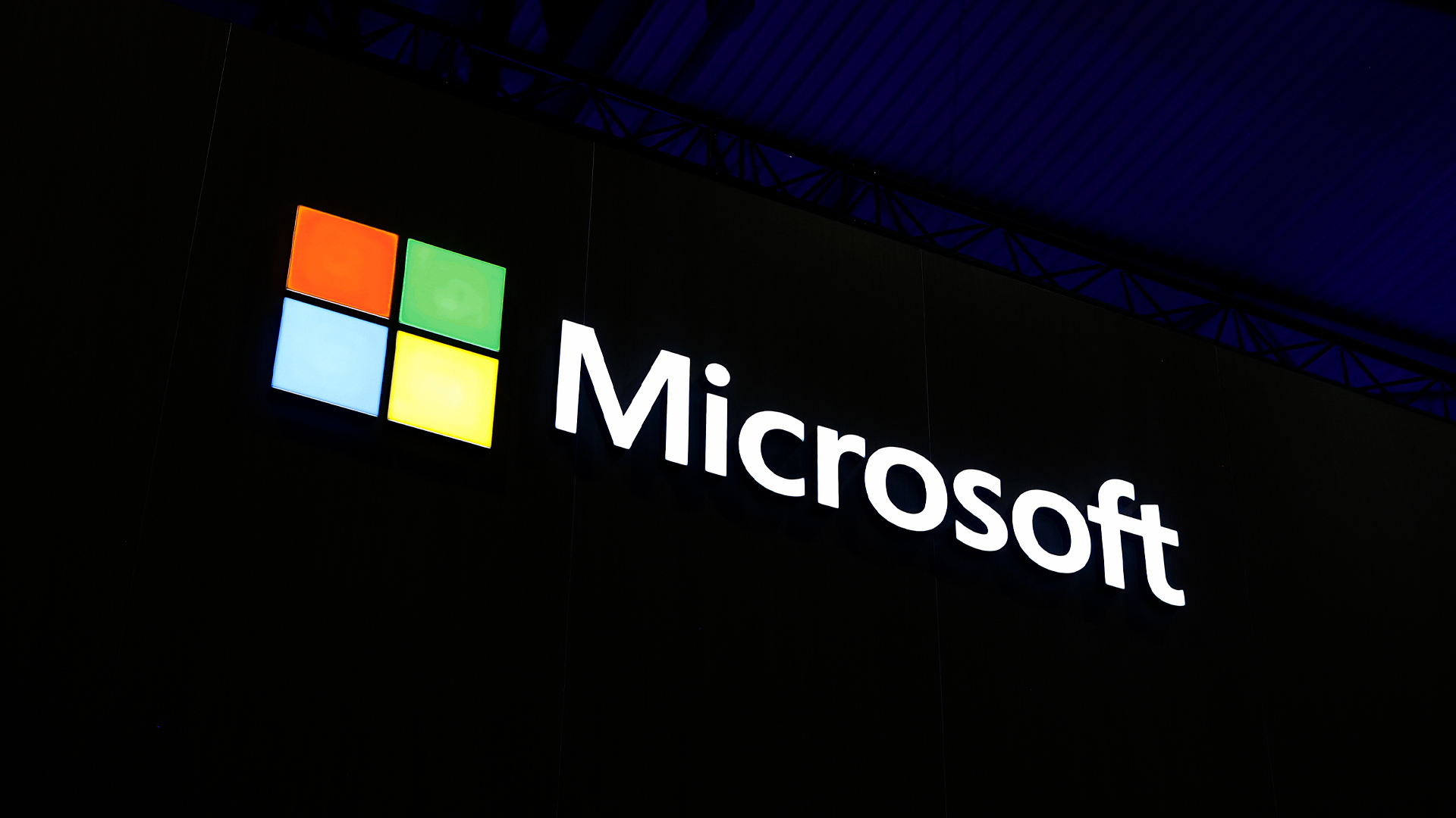 Microsoft logo and branding illuminated against a dark background at Mobile World Congress (MWC) in Barcelona, Spain.