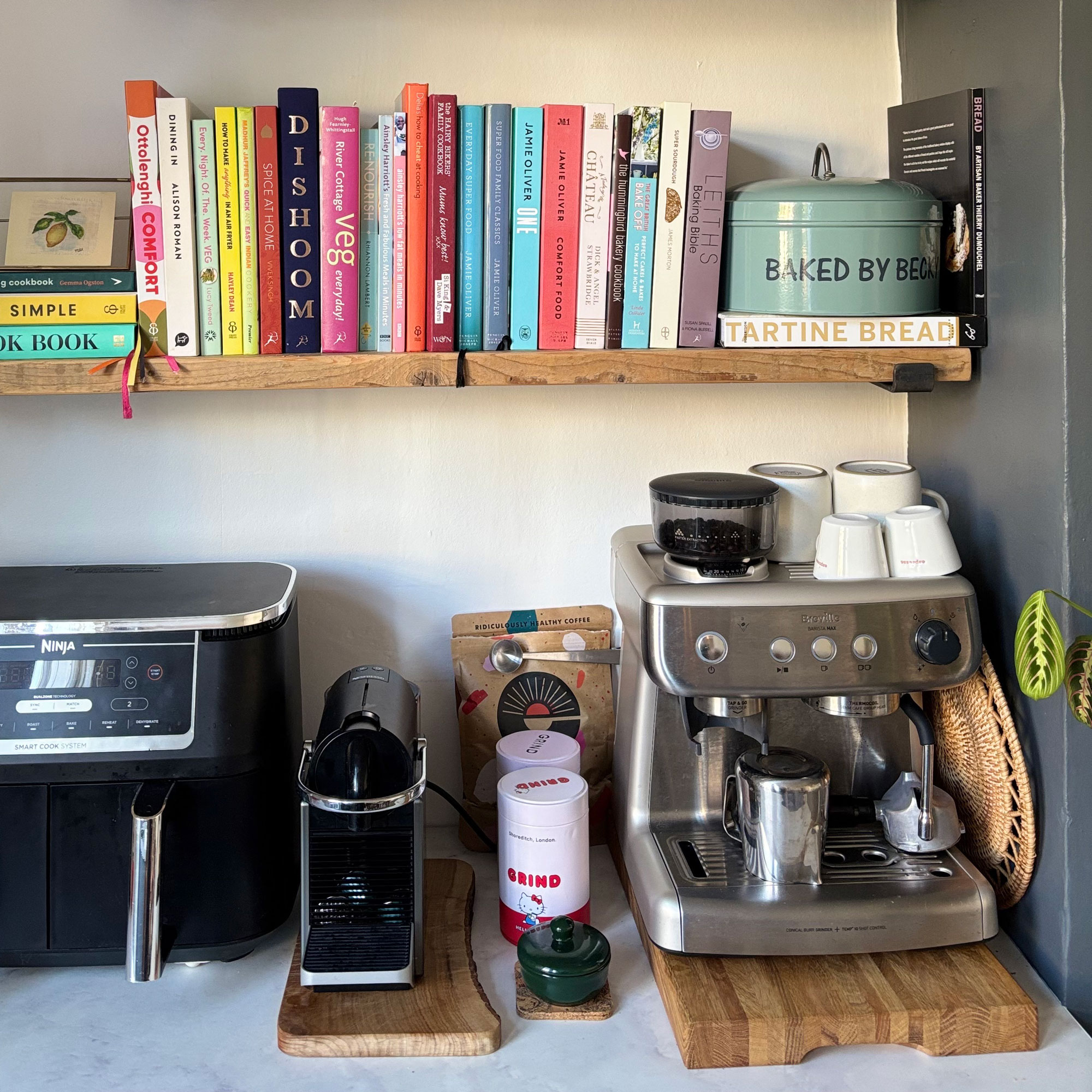 Coffee machine on a white counter with a blue wall in the background