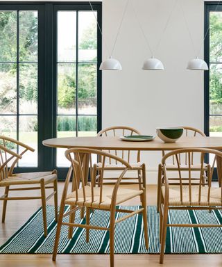 Dining room with modern dining chairs and large windows