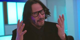 Keanu Reeves wears fake glasses and holds his hands out in Netflix Always Be My Maybe