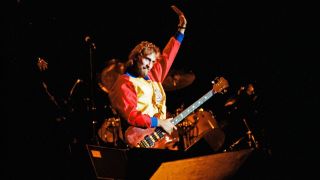 Mike Rutherford waves to the crowd after performing on stage with Genesis at the reunion concert 'Six of the Best' at The National Bowl on October 2nd, 1982 in Milton Keynes, United Kingdom.