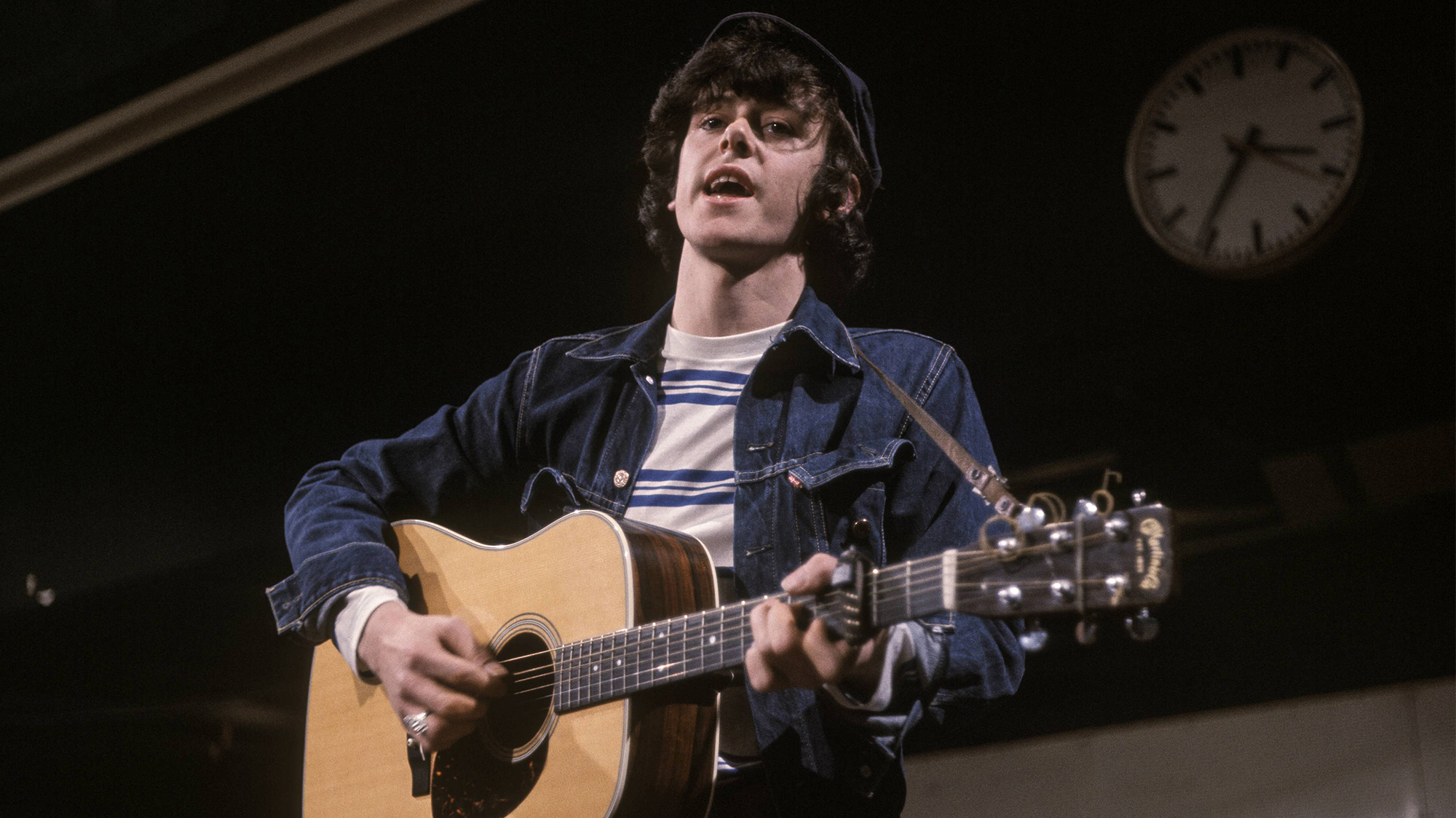 Donovan, playing a Martin acoustic guitar, performs on the music television series Ready Steady Go! at Kingsway studios in London in April 1965.