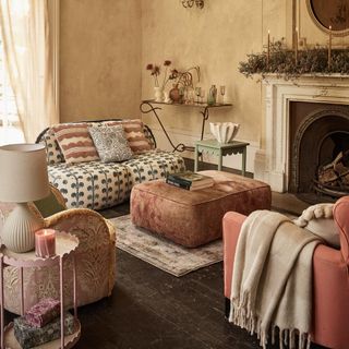 sofa in a living room with pouffe and side tables