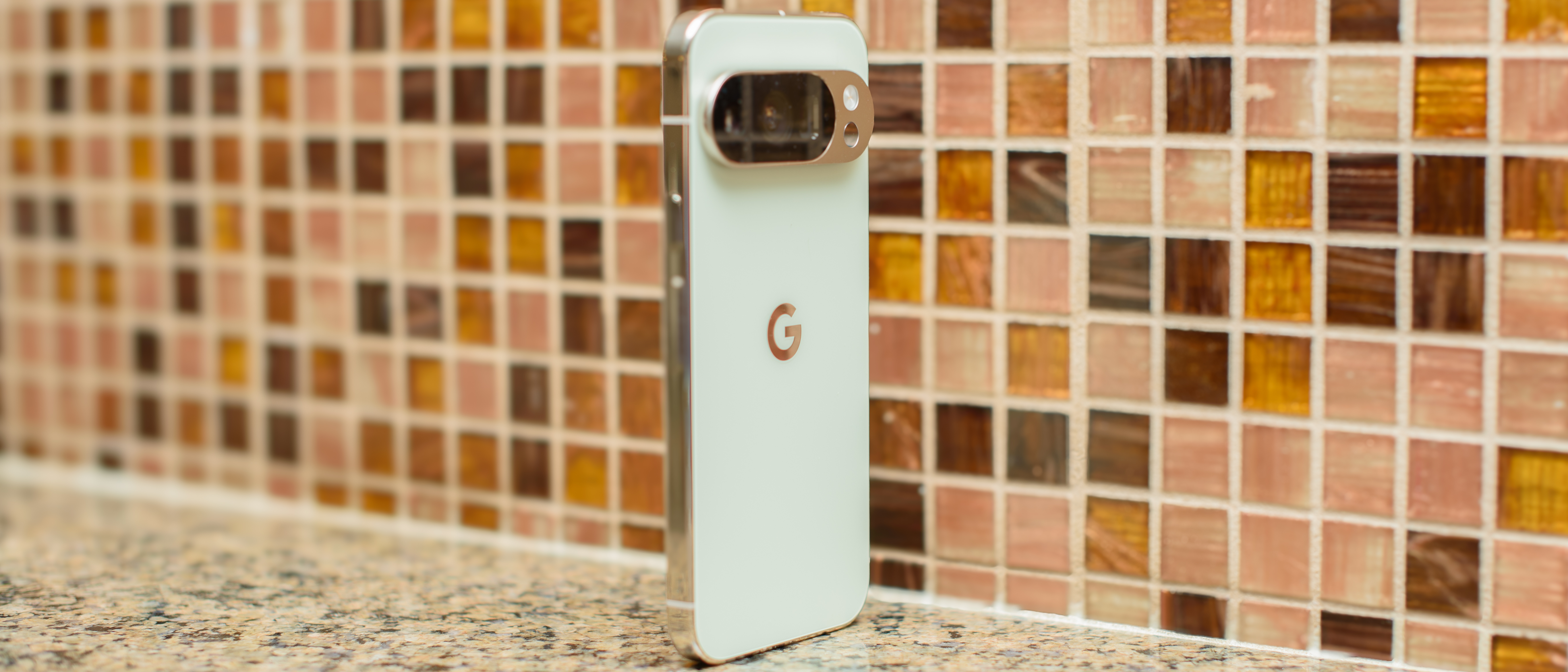 Google Pixel 10 Pro in Jade with checkered tile backsplash background