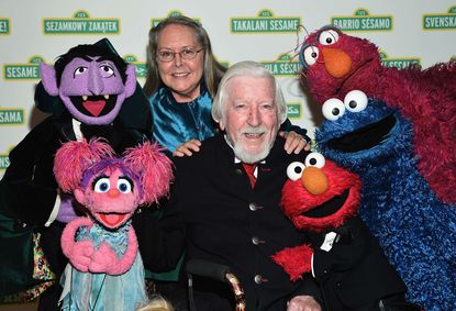 Caroll Spinney with several Muppets.