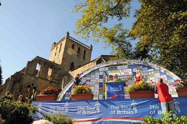 Riders sign in for stage 3 in the shadow of Jedburgh Abbey.