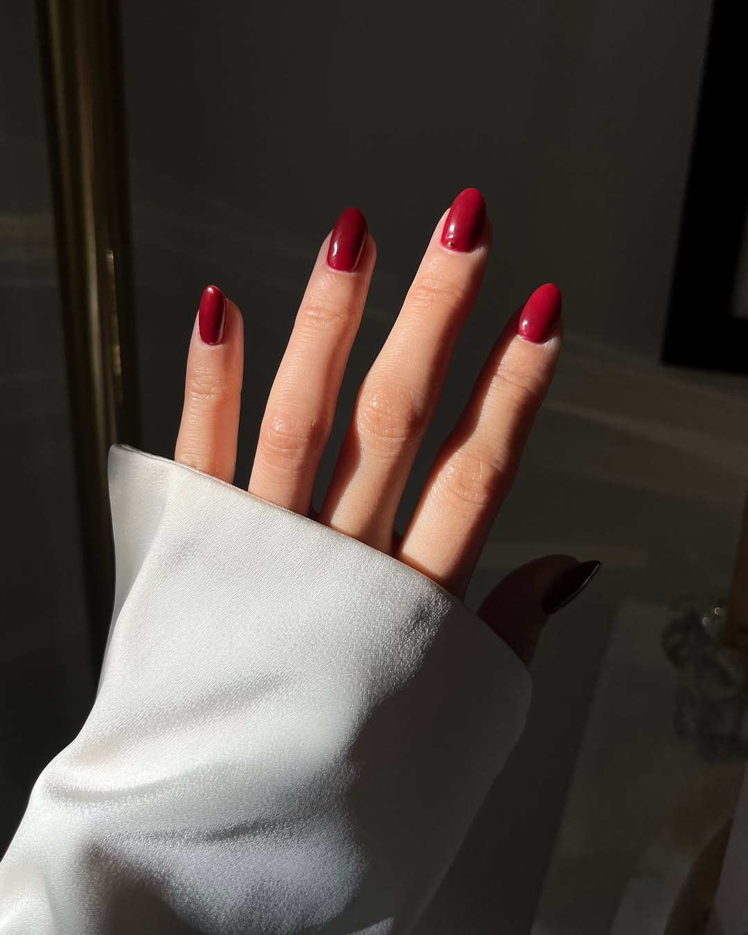 An image showing @leatngu's hand with red nail polish
