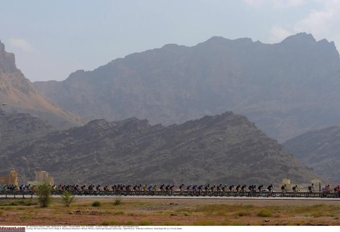 The Tour of Oman peloton rolls along during stage 3 from Bank Muscat to Al Bustan