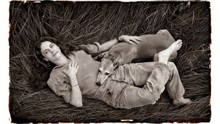 MAY 24 , 2024: Photographer Sally Mann relaxes with her dog "Honey" in a meadow of tall grass on her farm near Lexington, Virginia, USA. (Photo by Michael Williamson/The Washington Post via Getty Images)