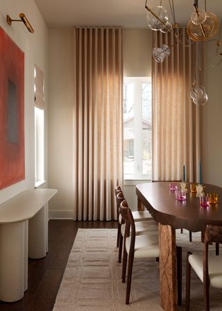 A modern dining room with bright walls and colorful glassware