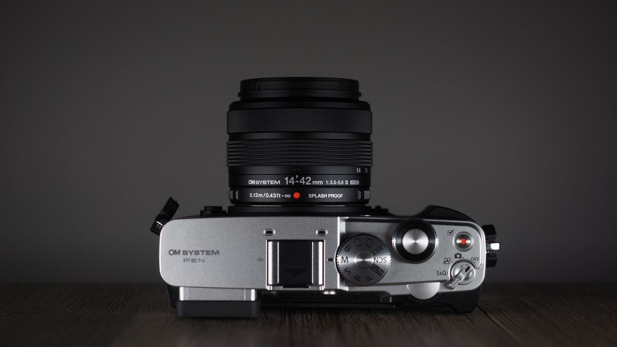 OM System OM-3 with the OM System M.Zuiko 14-42mm 3.5-5.6 III on a wooden surface