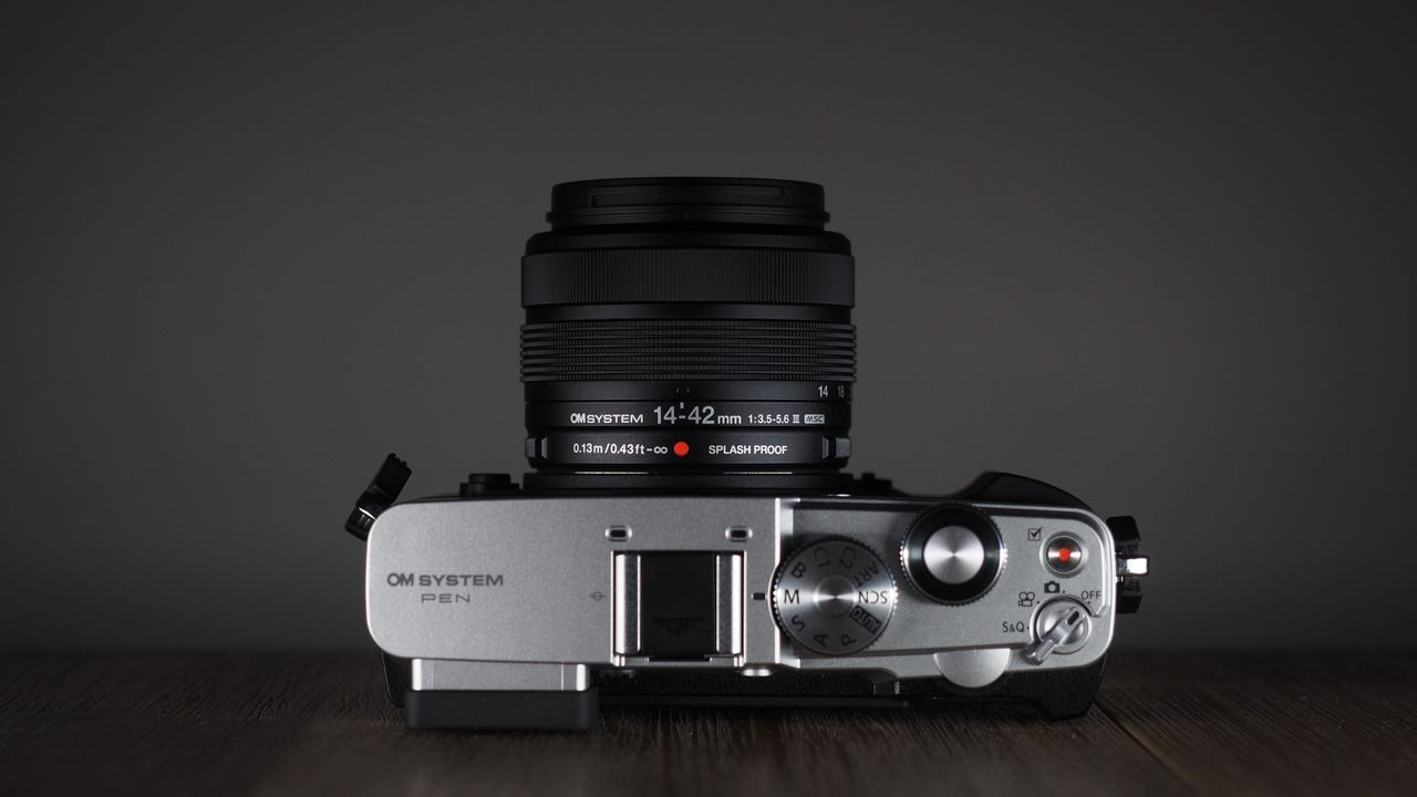 OM System OM-3 with the OM System M.Zuiko 14-42mm 3.5-5.6 III on a wooden surface