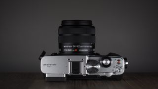 OM System OM-3 with the OM System M.Zuiko 14-42mm 3.5-5.6 III on a wooden surface