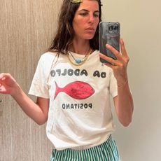 Woman in graphic tee and striped shorts