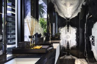 A dramatic black and white bookmatch slab shower