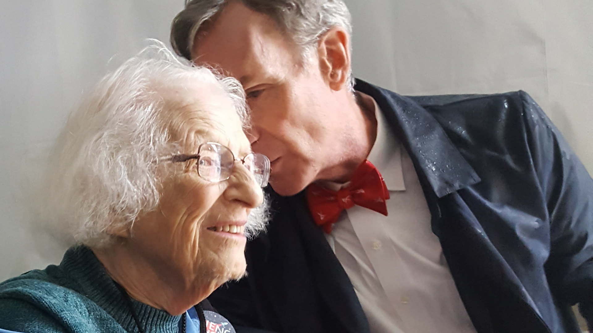 Bill Nye whispers something to Nancy Grace Roman. 
