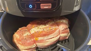 A turkey being cooked in the air fryer to show what you need to know before buying an air fryer