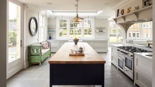 large white kitchen with black painted kitchen island in the center