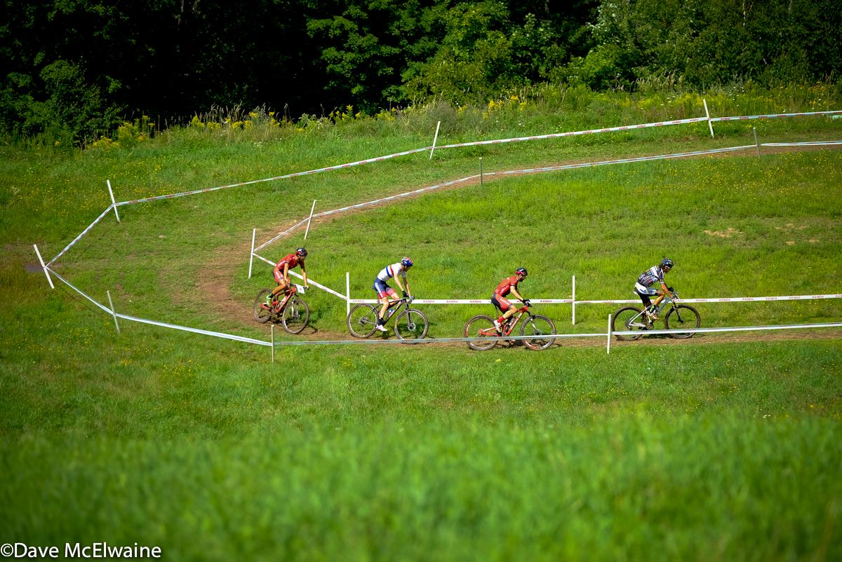 Lukas Baum (UCI MTB) leading a group of four at the top of the first mountain climb