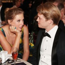 Taylor Swift and Joe Alwyn sitting together at the 77th Golden Globe Awards