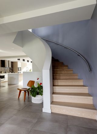 A modern sweeping staircase with a minimalist design