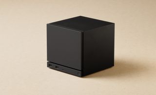 Valve Steam Machine render showing the cube-shaped desktop PC on a cream-colored background
