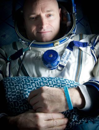 Expedition 26 Commander Scott Kelly wears a blue wrist band that has a peace symbol, a heart and the word "Gabby" to show his love of his sister-in-law U.S. Rep. Gabrielle Giffords as he rests shortly after he and cosmonauts Oleg Skripochka and Alexander Kaleri landed in their Soyuz TMA-01M capsule in Kazakhstan on March 16, 2011.