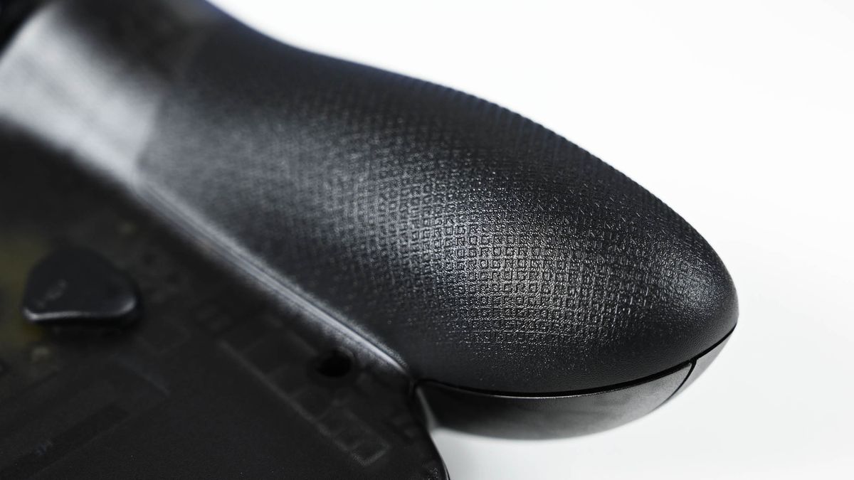 Close-up of the ROG Ally handheld grip, showing a textured anti-slip surface patterned with repeating micro "ROG" lettering