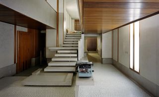 The interior design of Venice's Negozio Olivetti by architect Carlo Scarpa features an imposing stone staircase, wooden accents and a terrazzo floor