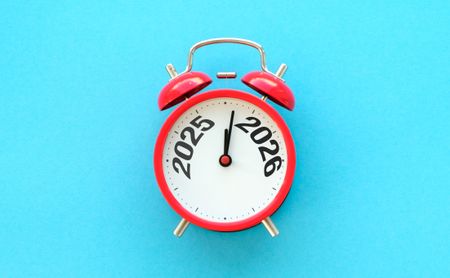 Happy New Year with red alarm clock and 2025 change to 2026 number. Merry Christmas, New Start, Resolution, countdown, Goals, Plan, Action and Mission Concept