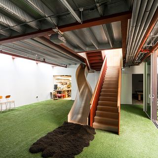 entrance way with green carpet and stairs